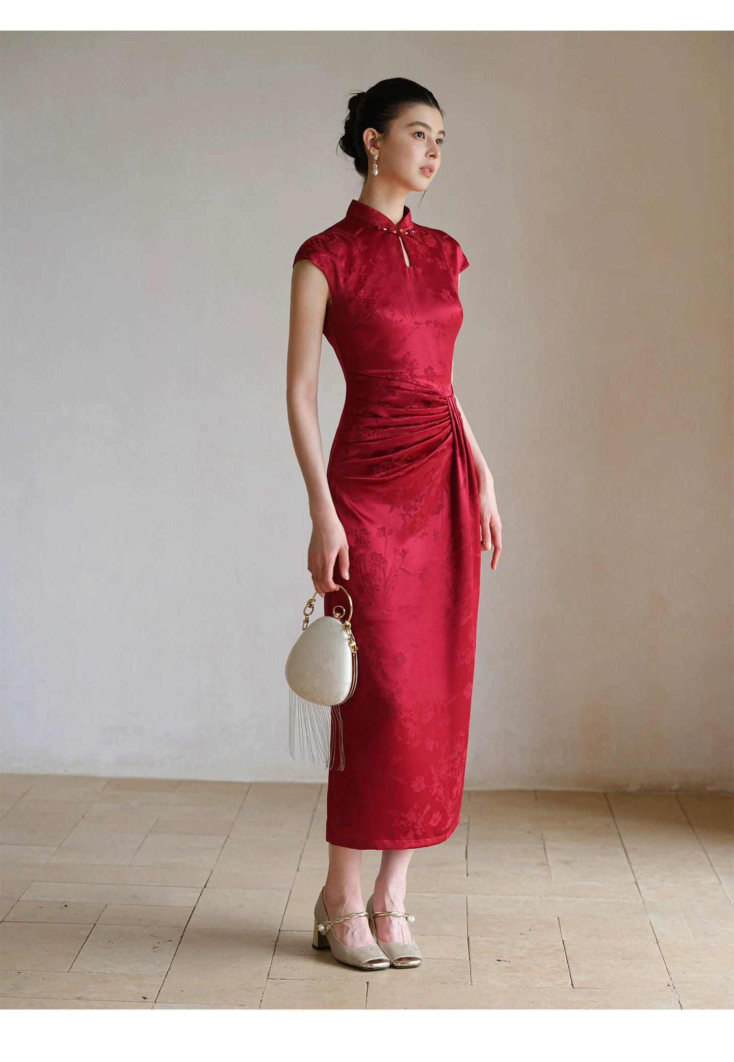 Occasion styling image of the Ruby Red acetate jacquard pleated qipao dress, presented as an elegant modern red qipao dress.