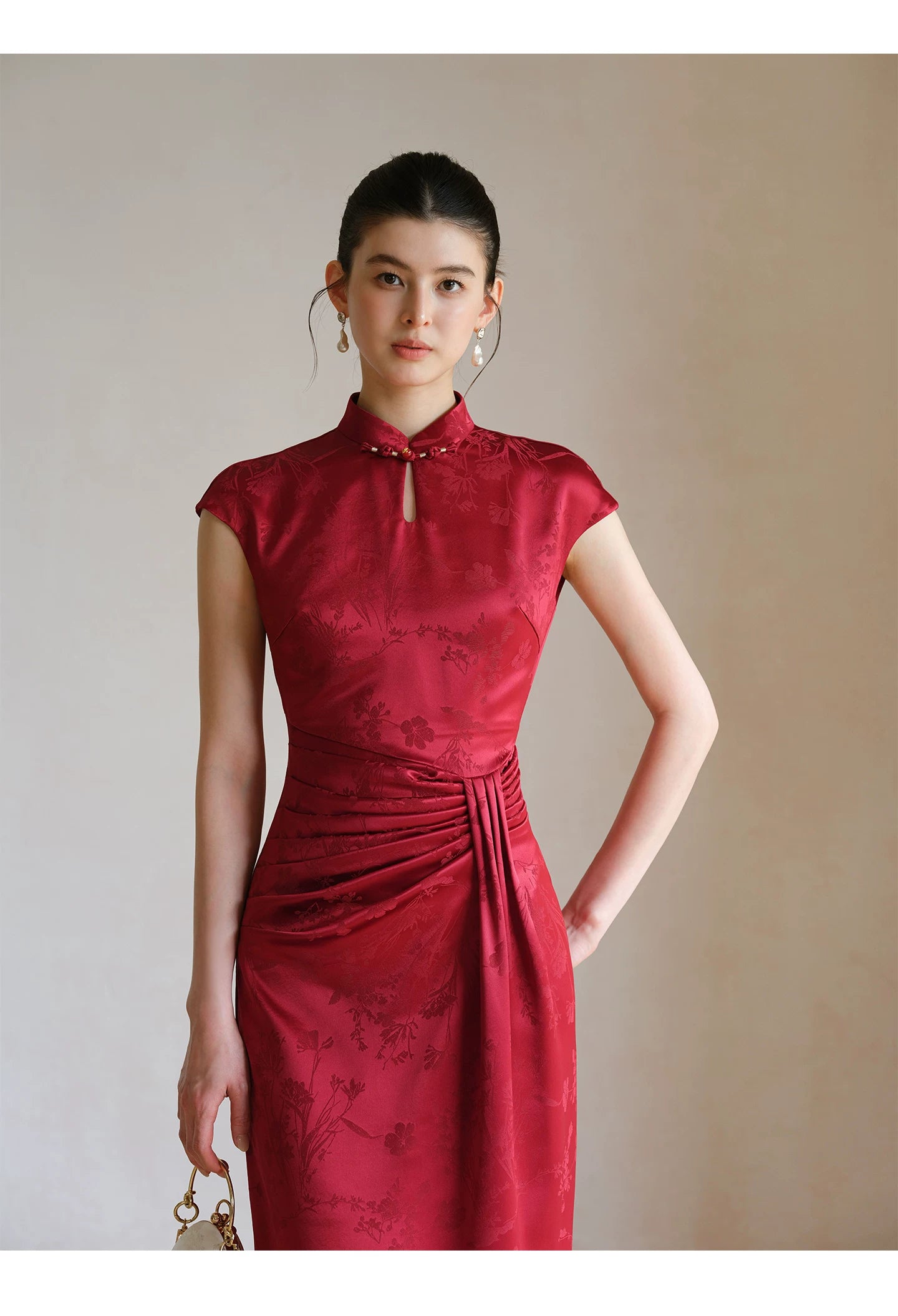 Three-quarter product view of the Ruby Red acetate jacquard pleated qipao dress, a refined modern red qipao dress for elegant occasions.
