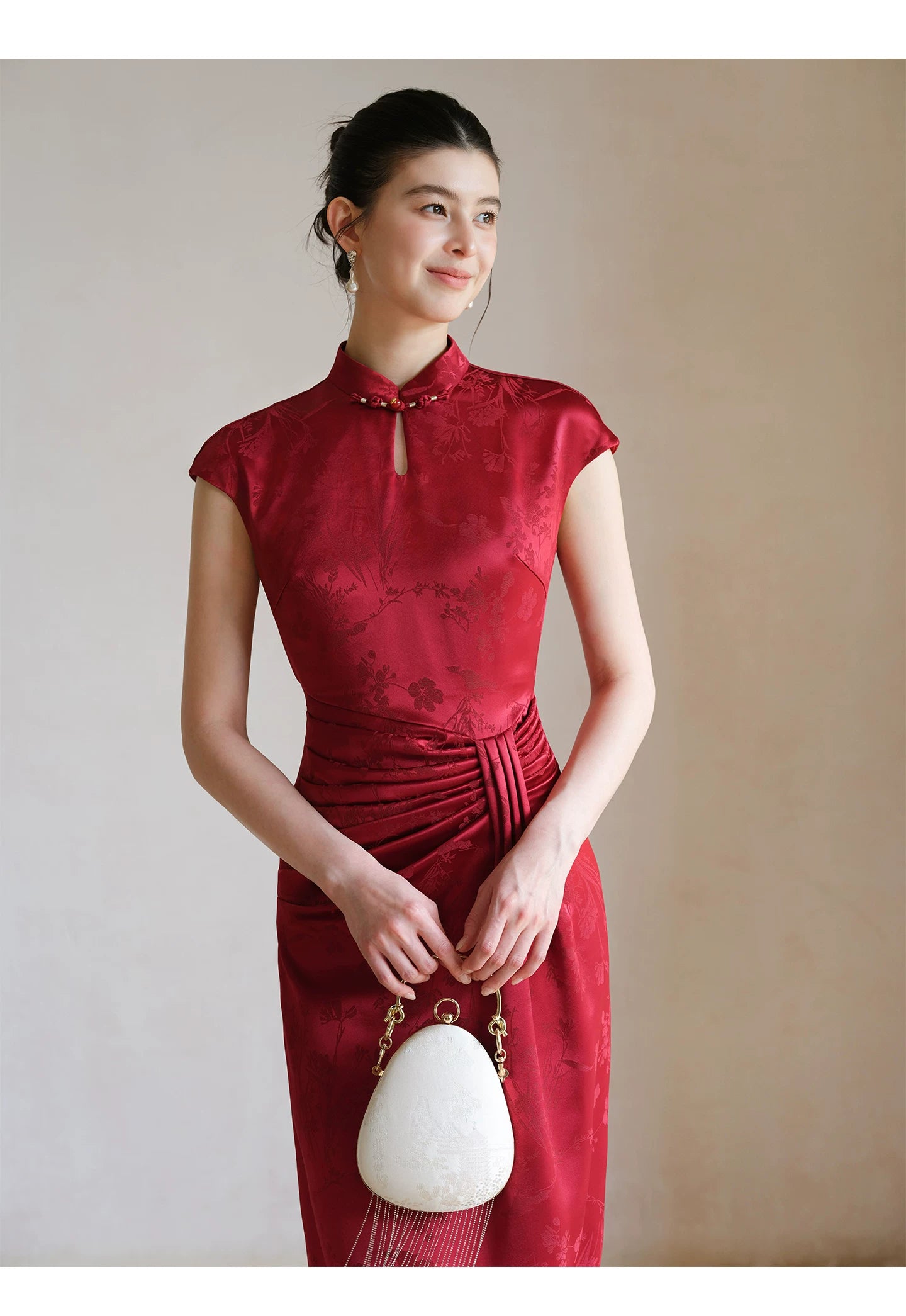 Design view of the Ruby Red acetate jacquard pleated qipao dress, highlighting acetate jacquard, sculpted pleats and elegant Chinese dress silhouette.