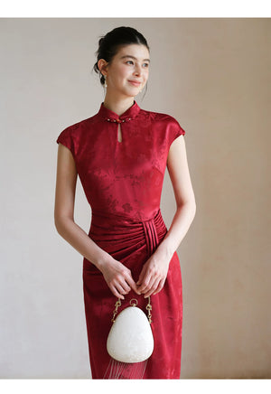 Design view of the Ruby Red acetate jacquard pleated qipao dress, highlighting acetate jacquard, sculpted pleats and elegant Chinese dress silhouette.