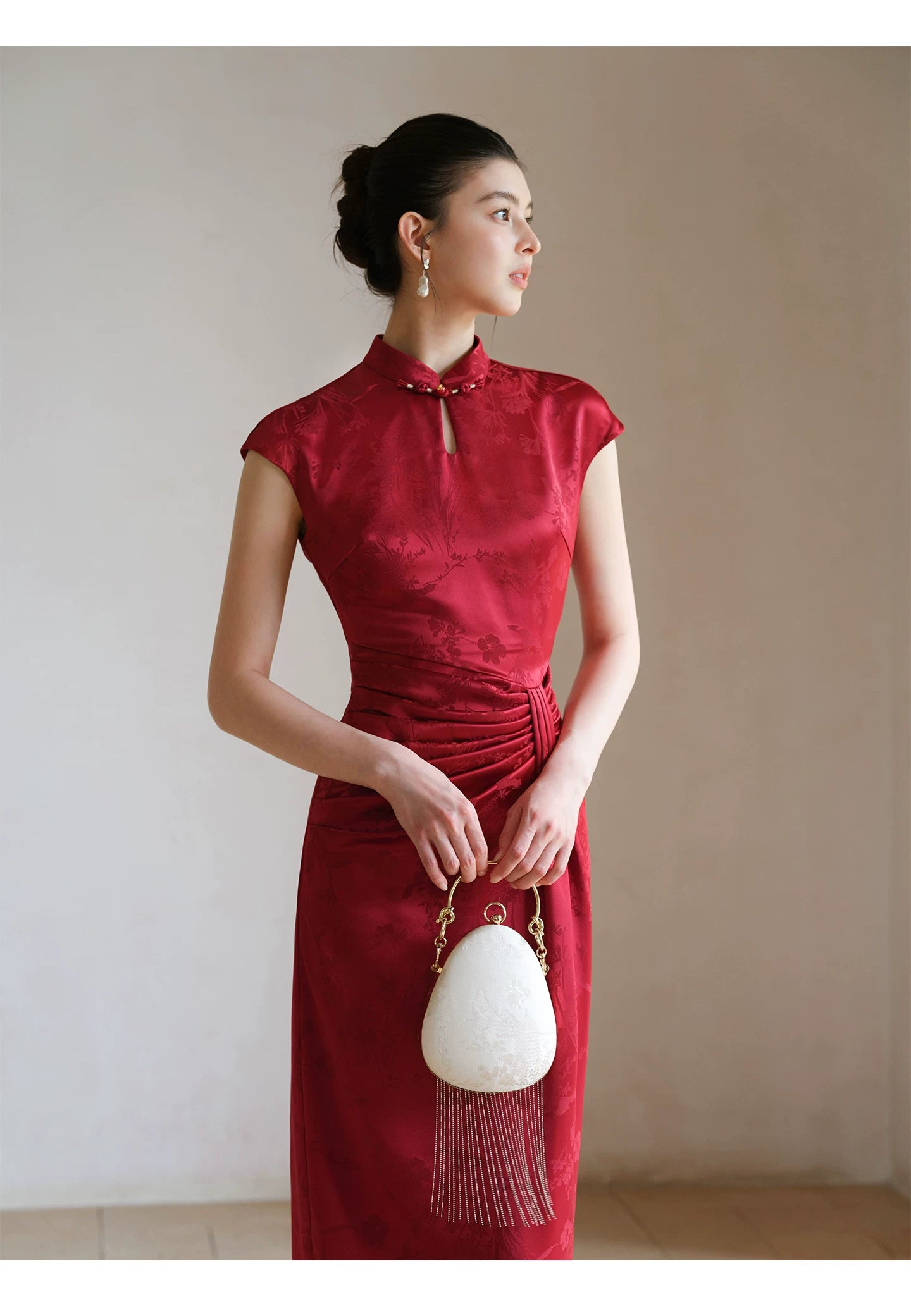 Close product view of the Ruby Red acetate jacquard pleated qipao dress, focused on its Chinese-inspired design details.