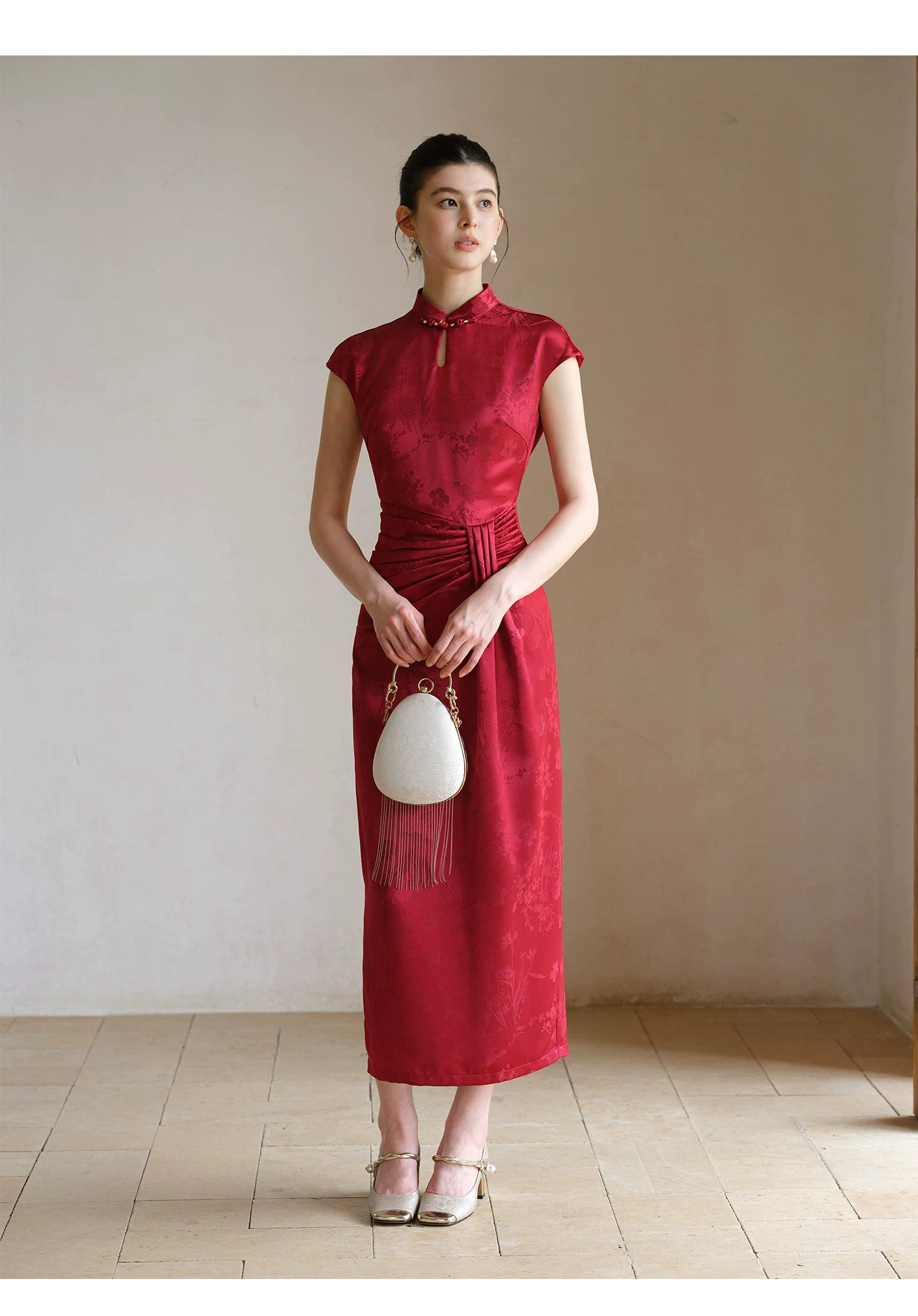 Occasion styling image of the Ruby Red acetate jacquard pleated qipao dress, presented as an elegant modern red qipao dress.