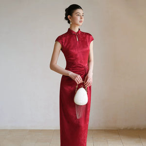 Three-quarter product view of the Ruby Red acetate jacquard pleated qipao dress, a refined modern red qipao dress for elegant occasions.