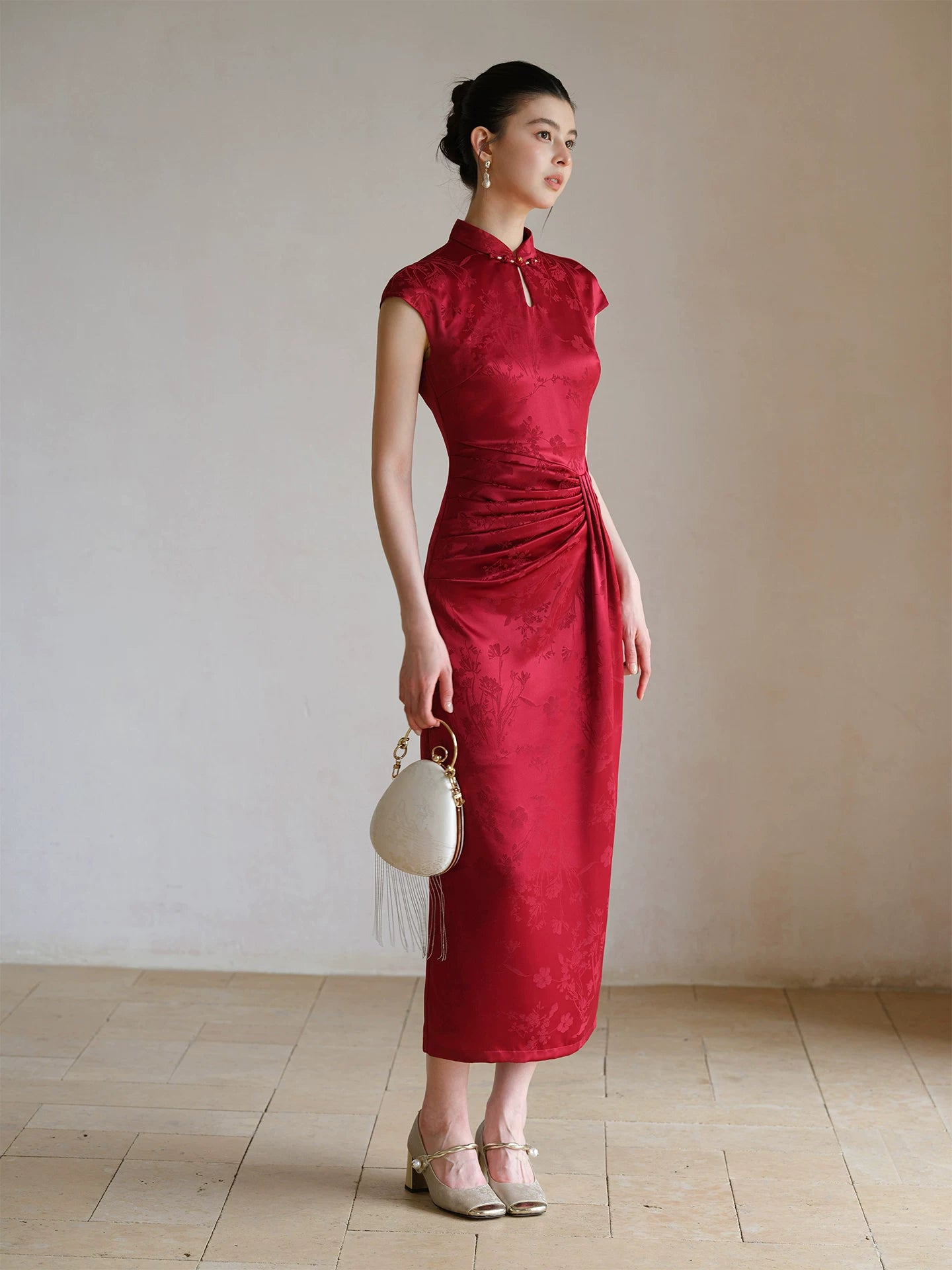 Ruby Red acetate jacquard pleated qipao dress styled to show its fit and drape, including acetate jacquard, sculpted pleats and elegant Chinese dress silhouette.