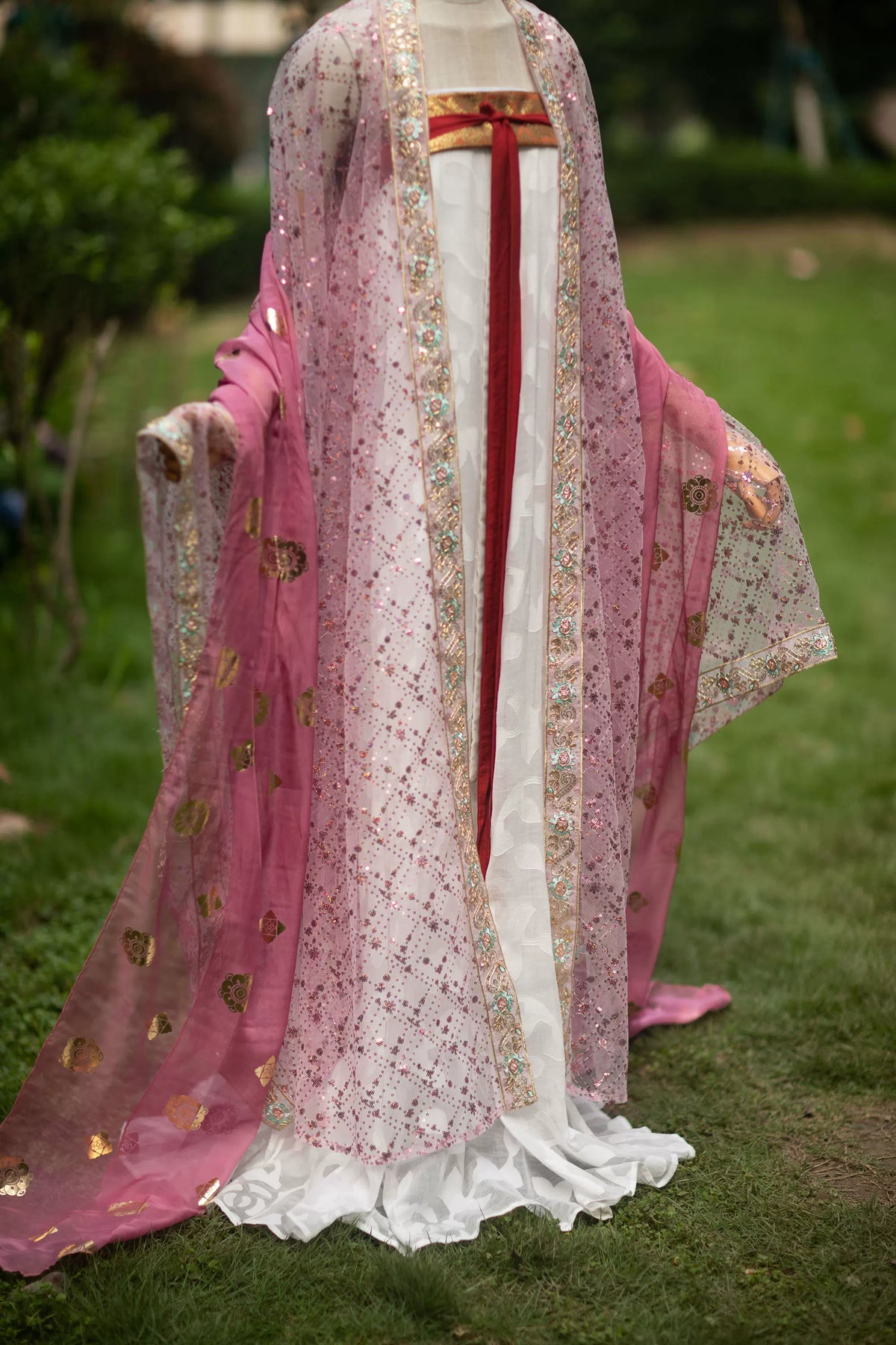Pink robe styling with the long pink gold-print pibo shawl draped over the arms