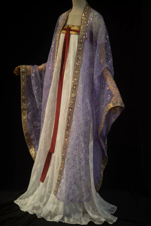 Full-length purple sequin robe styled over a flowing white skirt on a mannequin