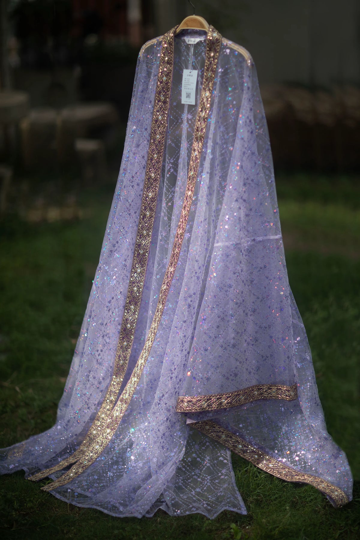 Purple sequin Hanfu robe displayed alone on a hanger with contrasting gold-tone trim
