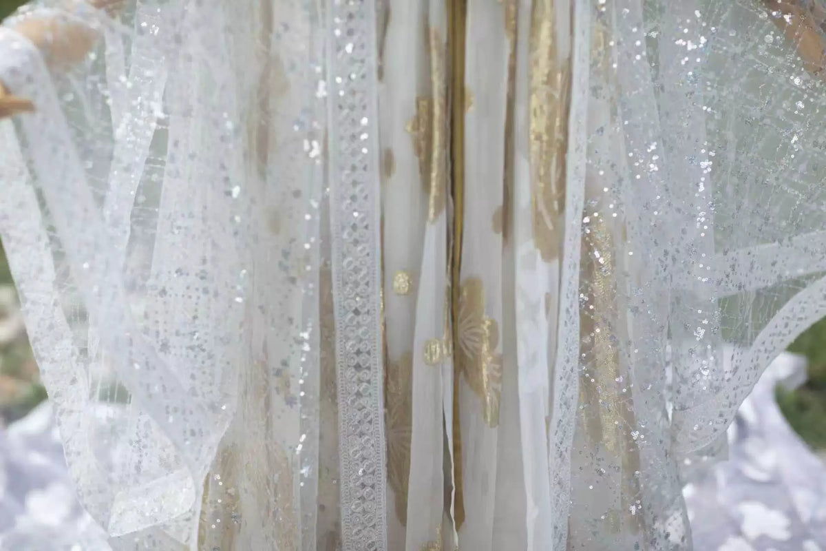 Close-up of white sequin robe panels and decorative white edging