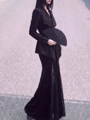 Side view of the black wrap jacket and asymmetric hem