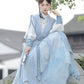 Blue hanfu dress for women, blending traditional Song Dynasty and modern Chinese styles, crafted from luxurious silk. This versatile hanfu includes options for a matching coat or jacket, making it suitable for winter wear, Chinese New Year celebrations, or casual outings. Ideal for occasions like graduations or cosplay, this dress embodies the fairy-inspired elegance of classic hanfu while also drawing from martial arts clothing and contemporary Chinese fashion. Available for purchase in our online hanfu sh