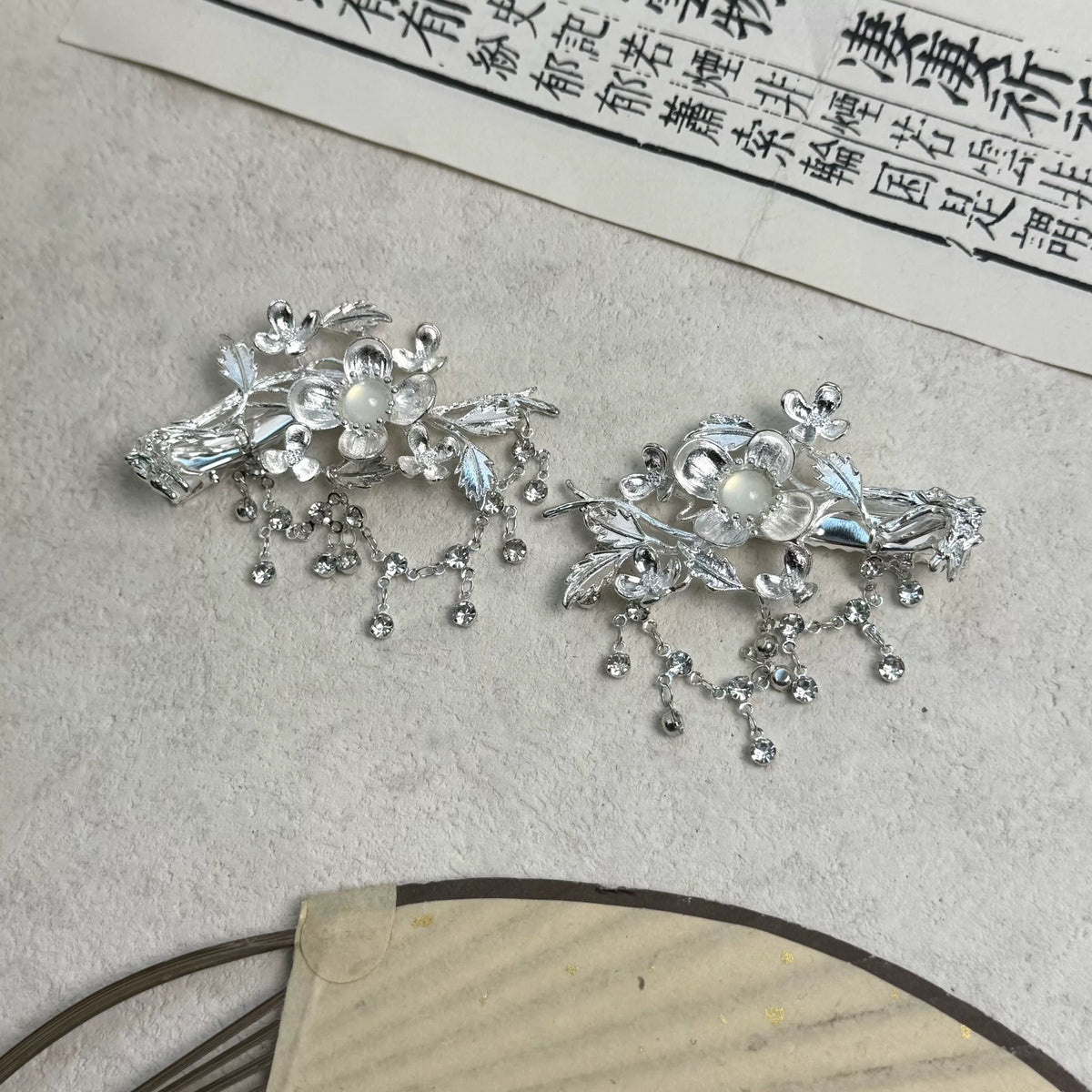 Silver-tone floral hair clips displayed flat