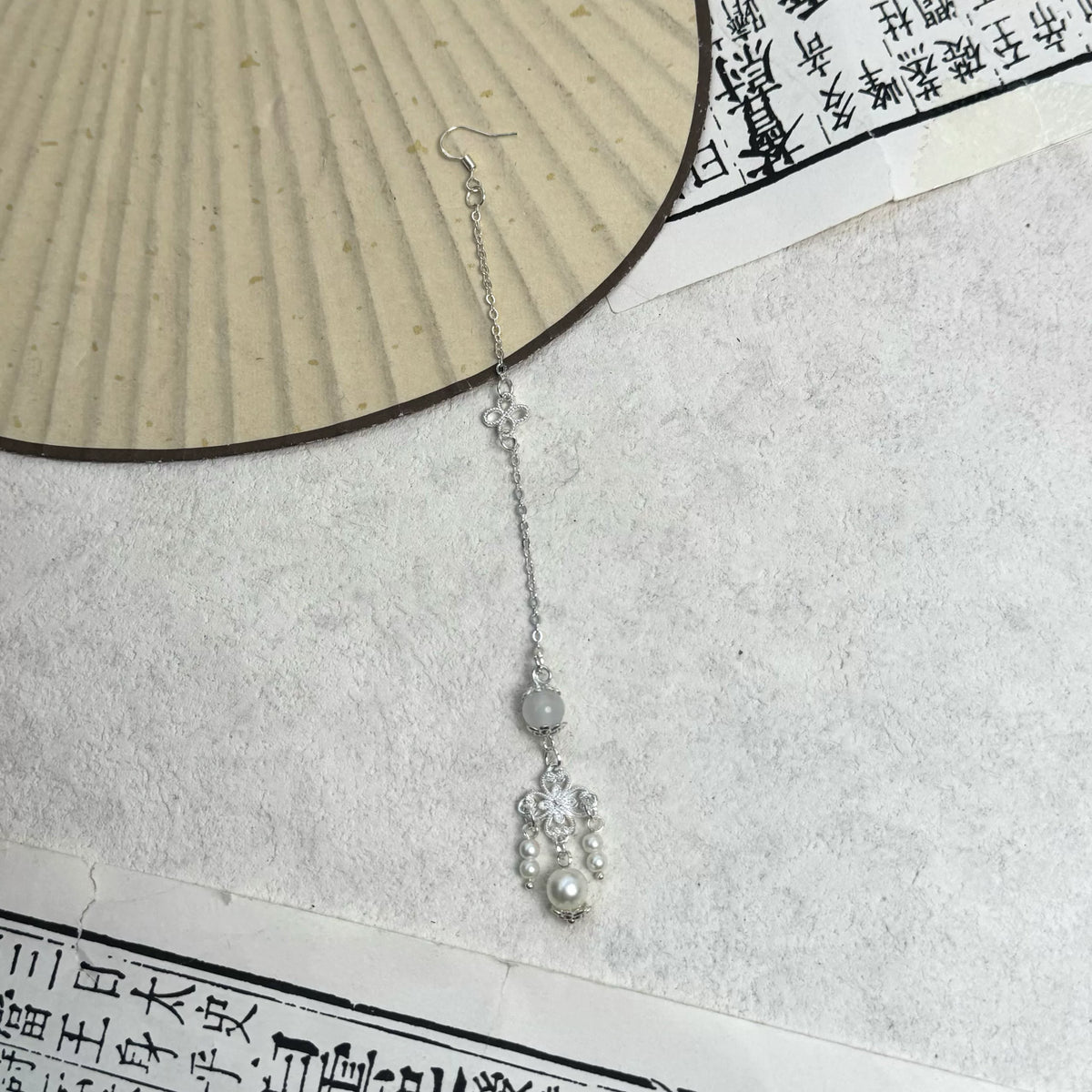 Silver-tone forehead ornament with a hanging accent