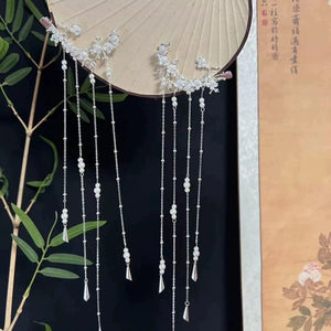 Pair of long tassel hair ornaments displayed on a fan