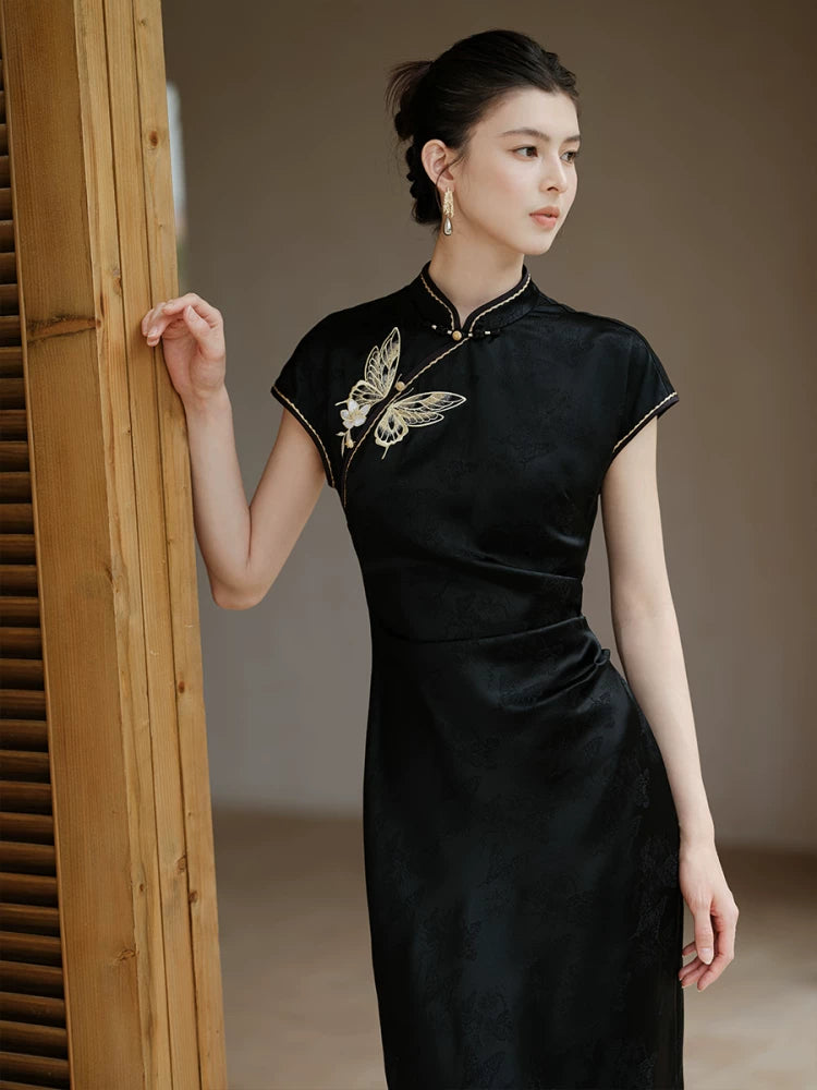 Front styling view of the Smoke-Ink black acetate embroidered long qipao dress, with acetate sheen, refined embroidery and long modern cheongsam silhouette.