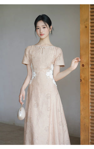Design view of the Soft Sand Pink floral applique cheongsam dress, highlighting pearl neckline, floral waist applique and long A-line silhouette.