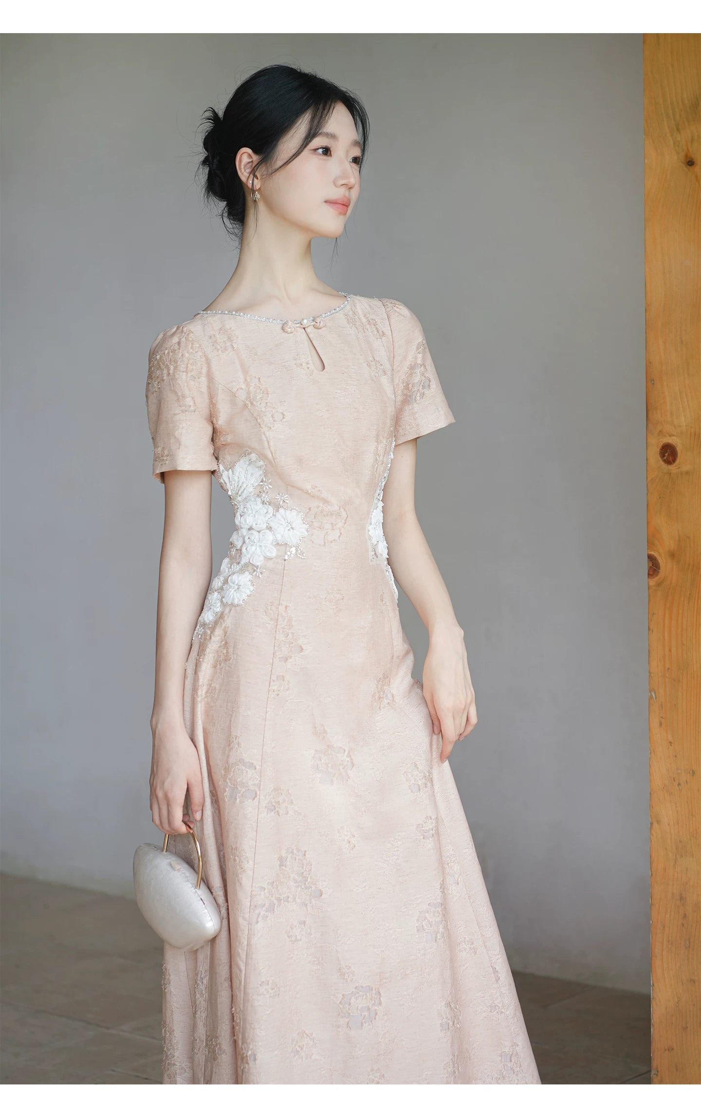 Detailed product image of the Soft Sand Pink floral applique cheongsam dress, showing fabric texture, finish and craftsmanship.