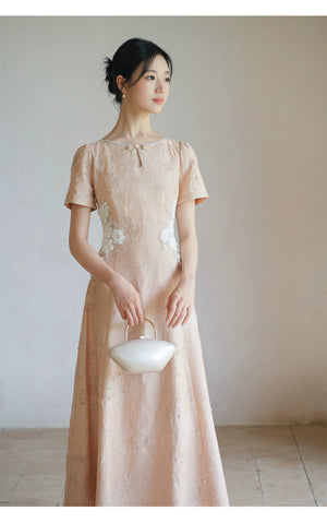 Close product view of the Soft Sand Pink floral applique cheongsam dress, focused on its Chinese-inspired design details.