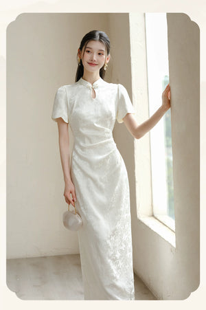 Detailed product image of the Soft White jacquard pleated qipao dress, showing fabric texture, finish and craftsmanship.
