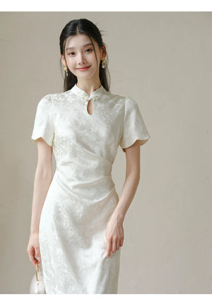 Close product view of the Soft White jacquard pleated qipao dress, focused on its Chinese-inspired design details.