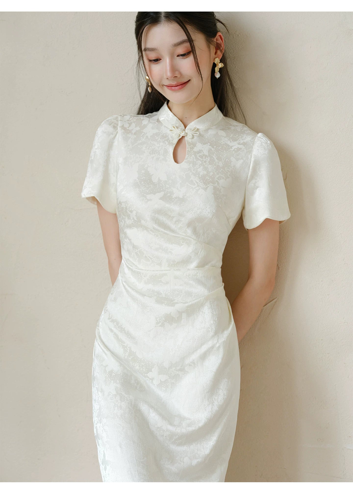Occasion styling image of the Soft White jacquard pleated qipao dress, presented as an elegant modern white qipao dress.