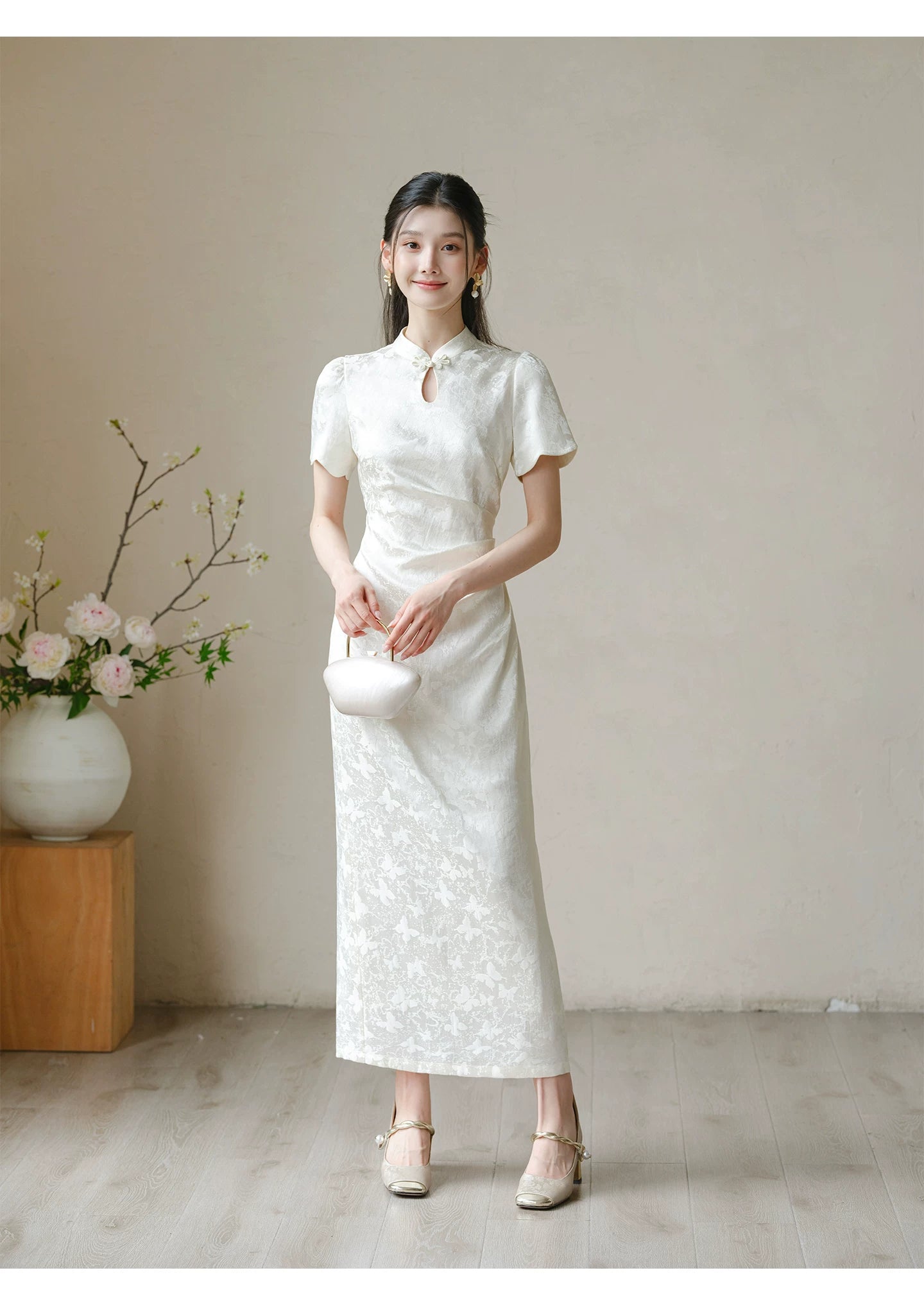 Soft White jacquard pleated qipao dress shown as a polished modern white qipao dress, highlighting subtle jacquard, fitted waist, front pleats and keyhole mandarin collar.