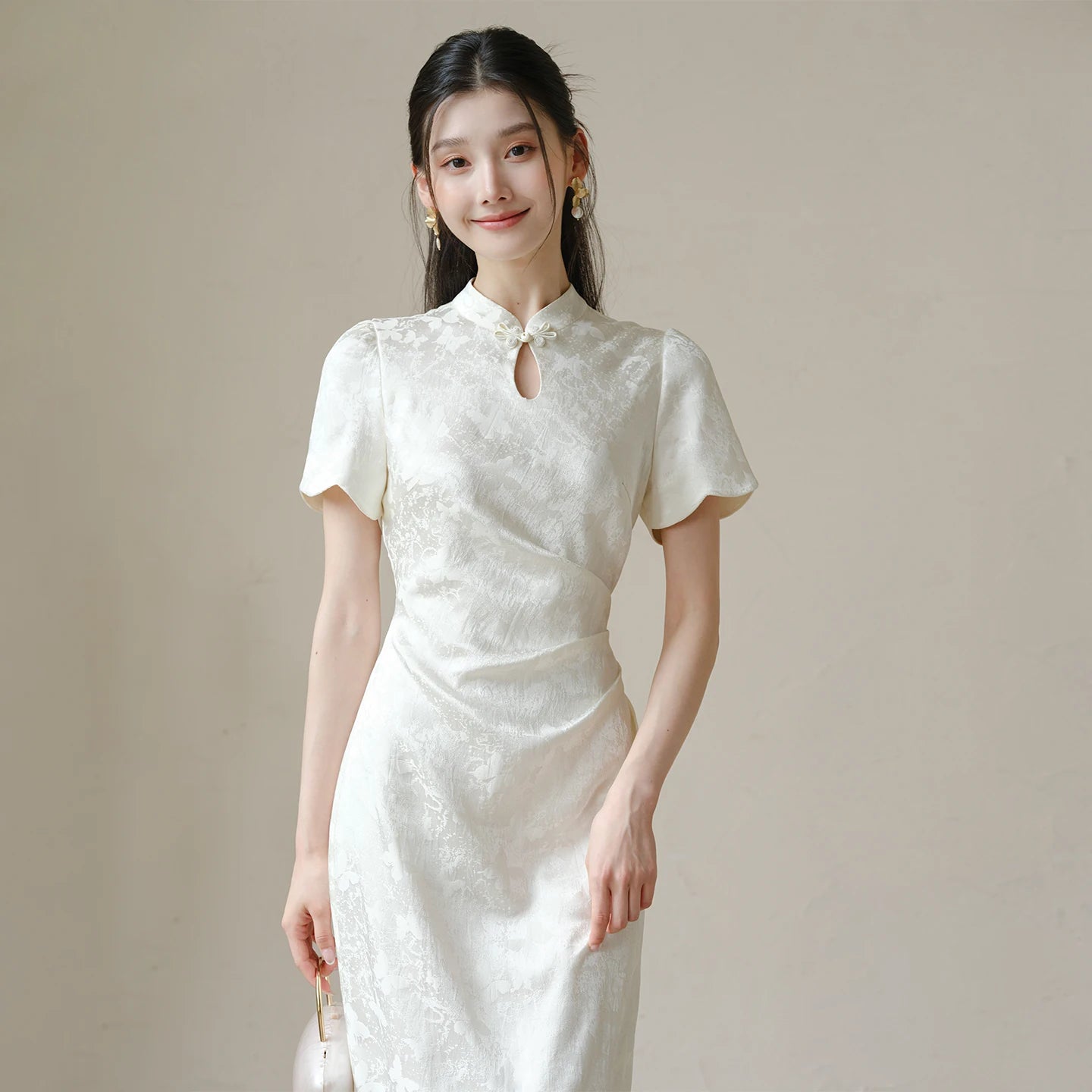 Close product view of the Soft White jacquard pleated qipao dress, focused on its Chinese-inspired design details.
