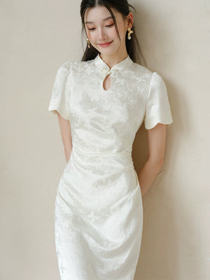 Three-quarter product view of the Soft White jacquard pleated qipao dress, a refined modern white qipao dress for elegant occasions.