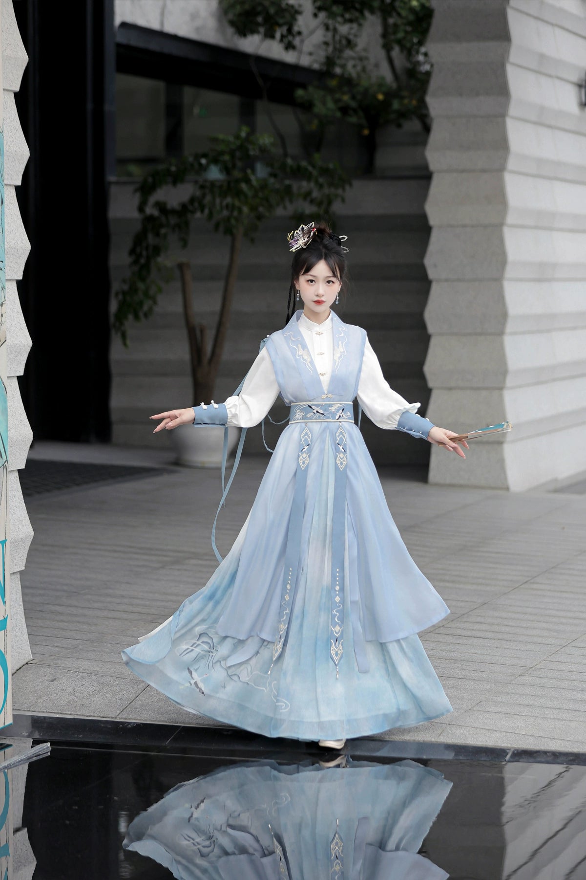 Blue hanfu dress for women, blending traditional Song Dynasty and modern Chinese styles, crafted from luxurious silk. This versatile hanfu includes options for a matching coat or jacket, making it suitable for winter wear, Chinese New Year celebrations, or casual outings. Ideal for occasions like graduations or cosplay, this dress embodies the fairy-inspired elegance of classic hanfu while also drawing from martial arts clothing and contemporary Chinese fashion. Available for purchase in our online hanfu sh