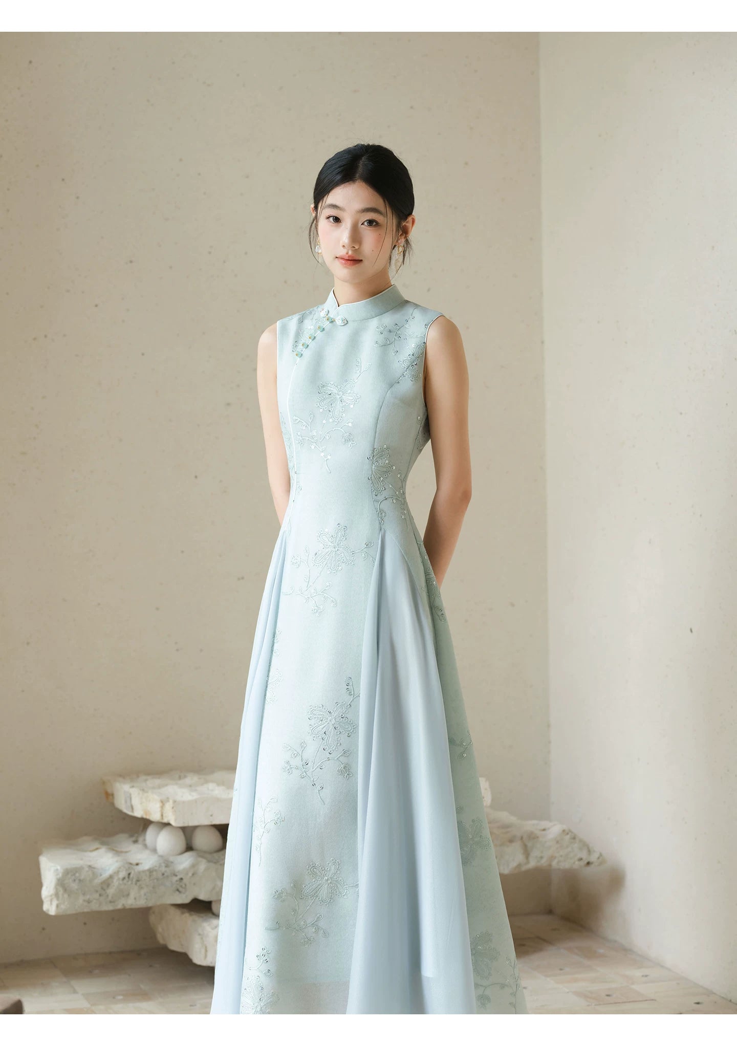 Additional styling view of the Water-Blue jacquard A-line qipao dress, showing the garment's shape, texture and finish.