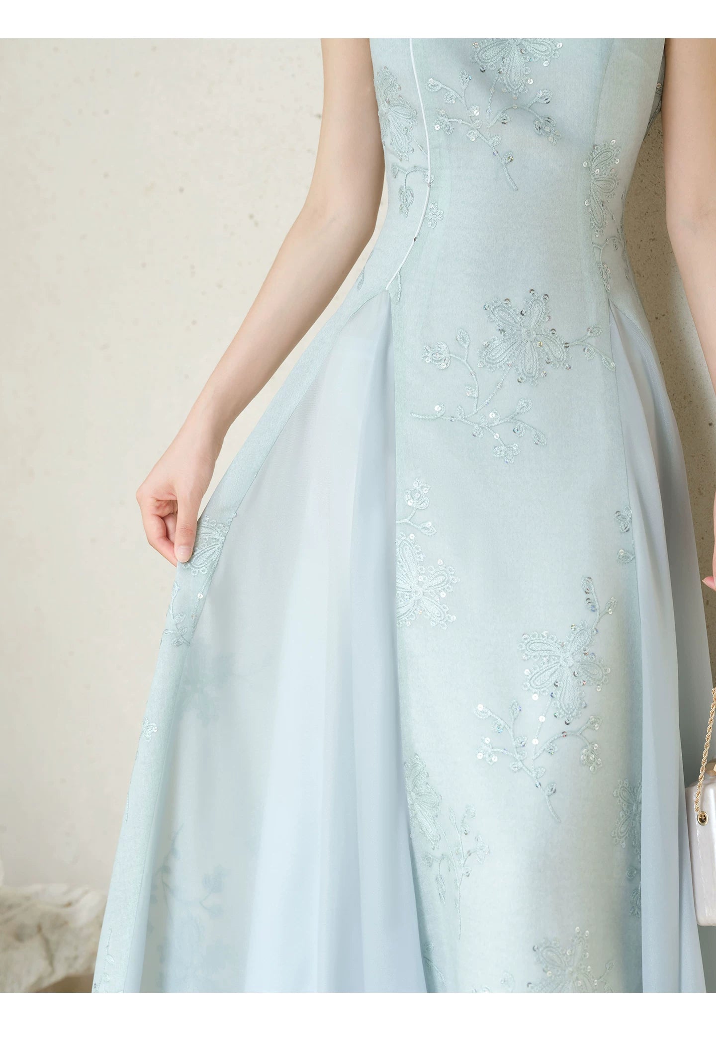 Additional styling view of the Water-Blue jacquard A-line qipao dress, showing the garment's shape, texture and finish.