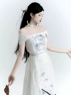 White butterfly Hanfu camisole with blue embroidery, shown with its wide straps draped off the shoulders