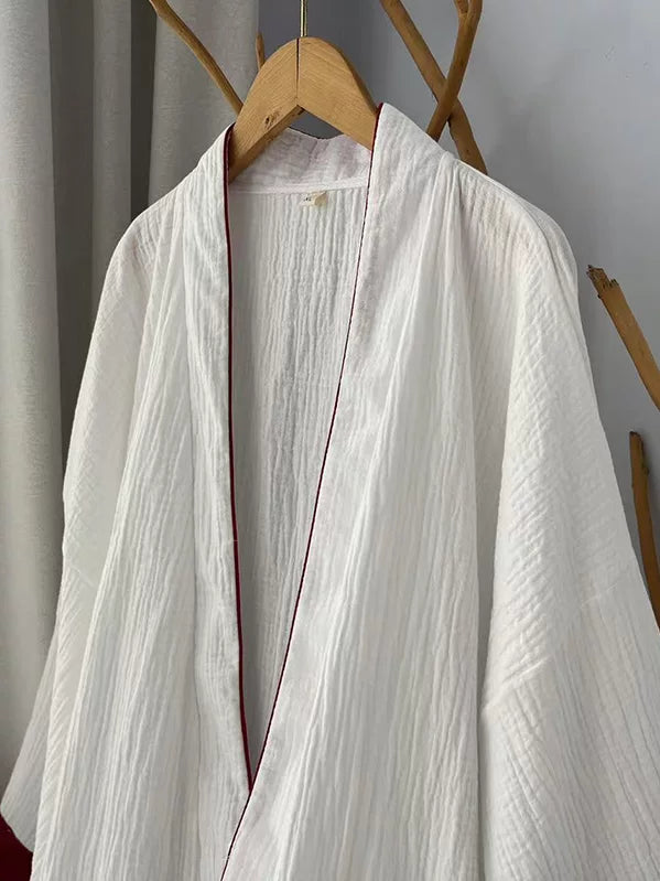 White cotton gauze robe showing wide sleeves and deep red cuff trim