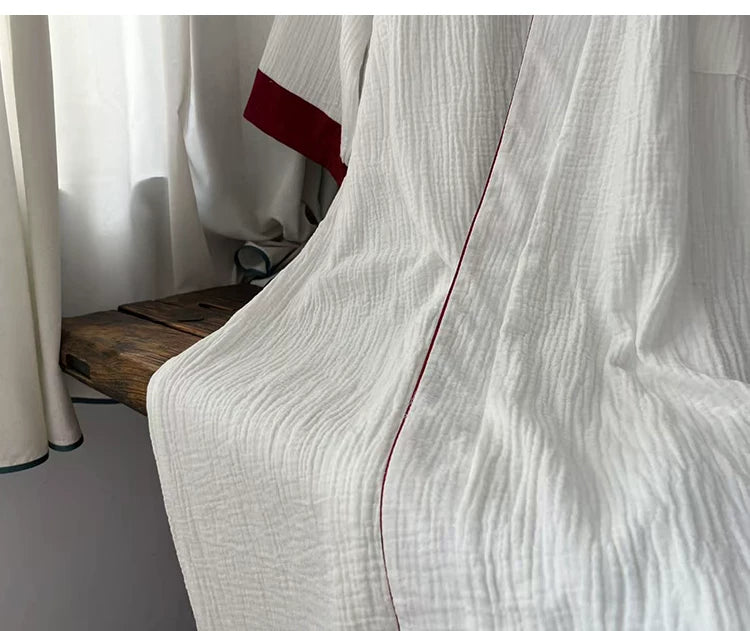 Red contrast piping and trim detail on the white New Chinese style robe