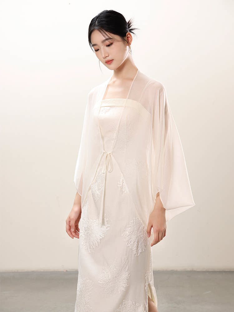 Design view of the White embroidered slip dress and sheer outer layer, highlighting embroidered slip dress, translucent outer layer and soft layered drape.
