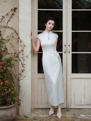 White iris cheongsam in acetate satin, full-length view beside garden doors