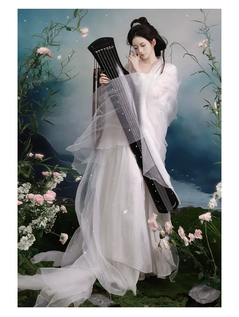 White layered Hanfu worn with a musical prop