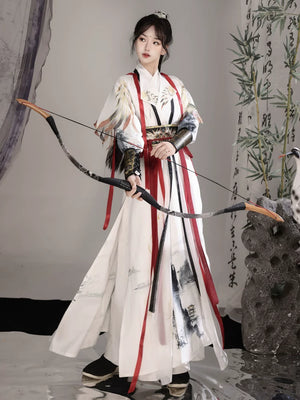 White Nanke warrior Hanfu costume showing the layered skirt, patterned waist sash and red ties
