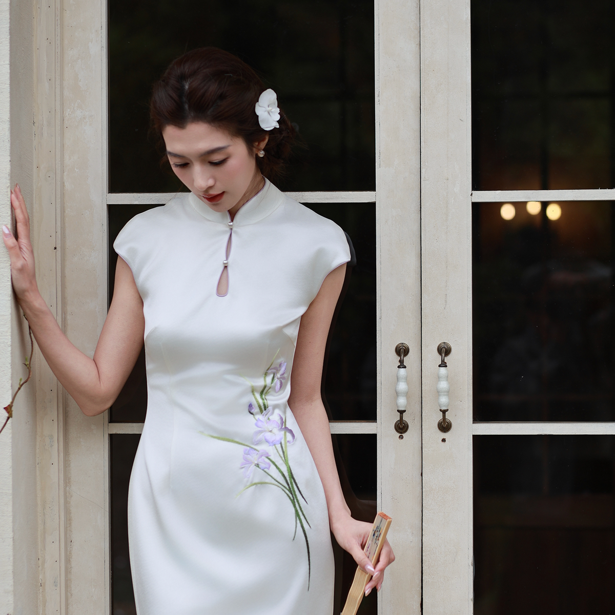 White satin cheongsam with purple iris and butterfly details, standing view