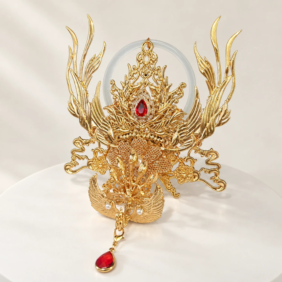 Gold-tone phoenix crown with red accent