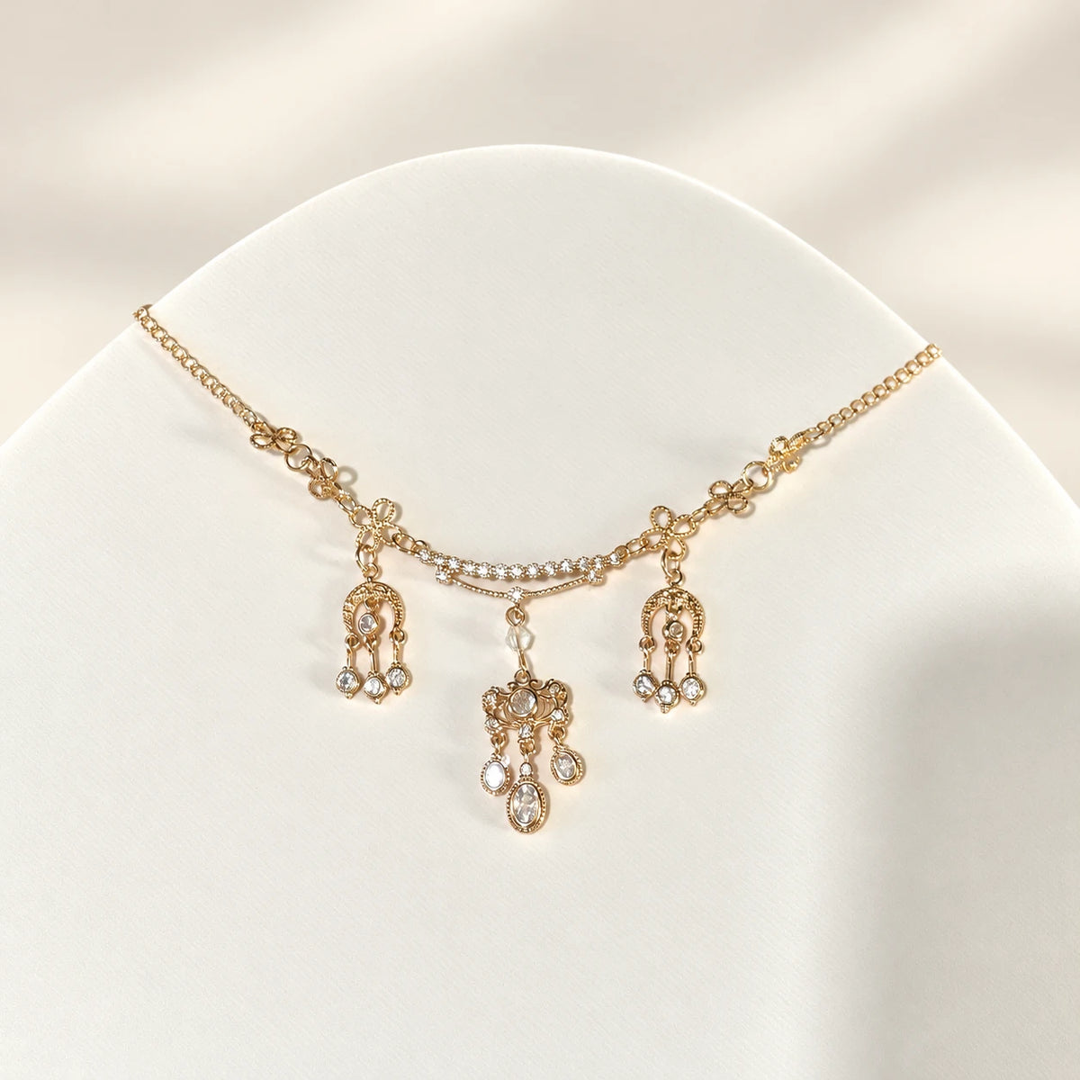 Gold-tone forehead chain with clear accents