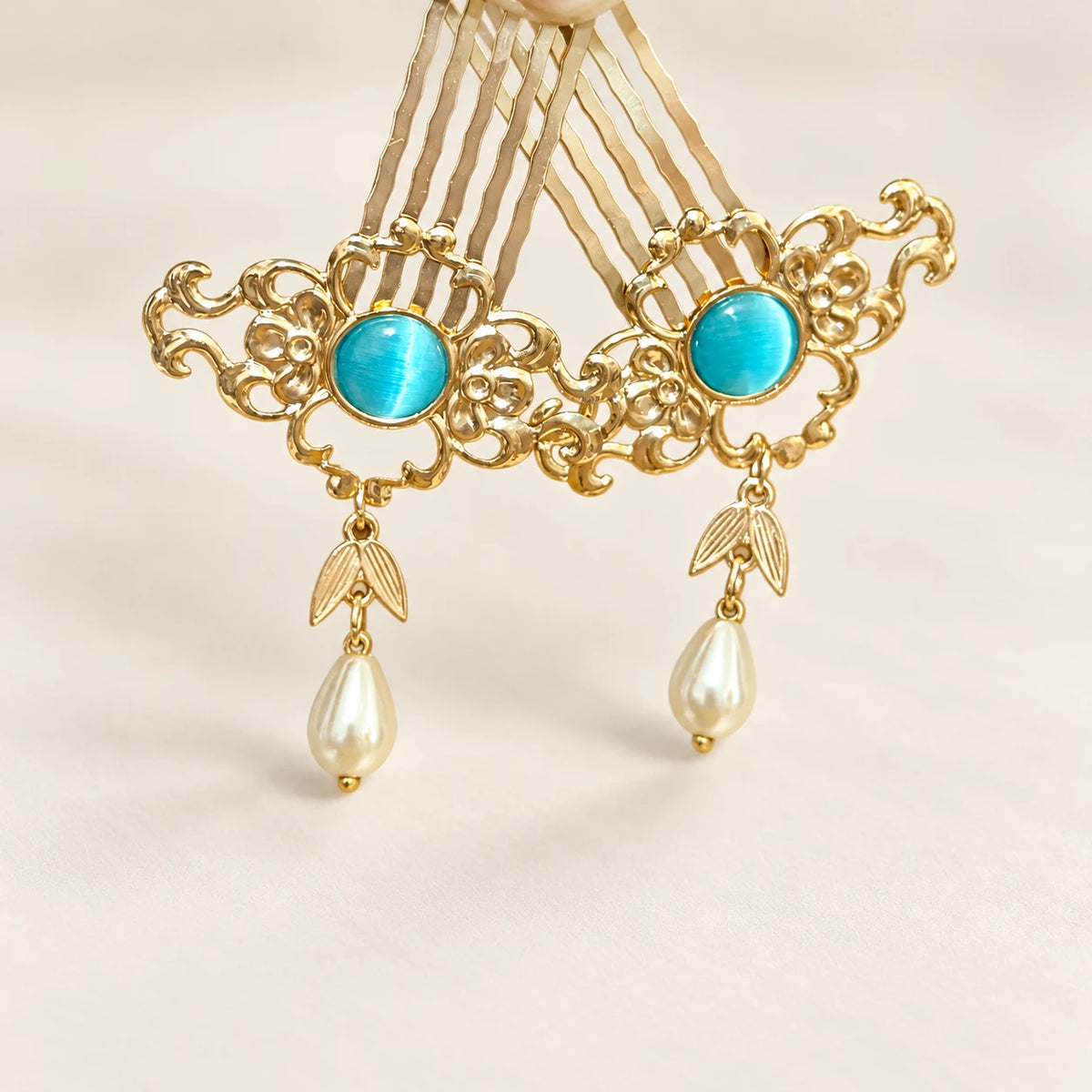 Small gold-tone phoenix hairpin with blue accents