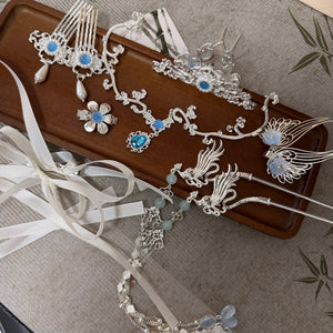 Silver-tone floral hair ornaments and ribbon accessories flat lay