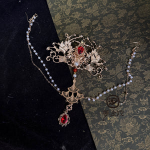 Gold-tone forehead crown with red decorative accents