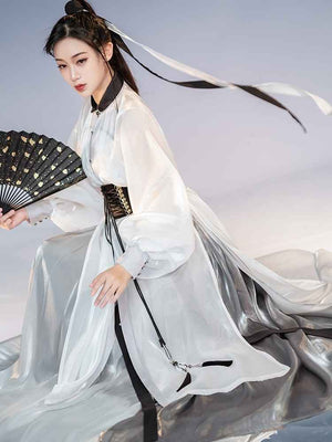 White Featuring a diverse collection of Hanfu styles, this display presents a blend of traditional and modern elements, from the intricate embroidery of classic Hanfu to contemporary menswear. The assortment includes authentic Tang Dynasty dresses and detailed Ming Dynasty Hanfu, alongside luxurious royal attire and scholar officials' outfits. With a special emphasis on men's Hanfu, the exhibit highlights the rich cultural tapestry of traditional Asian clothing and modern, Asian-inspired fashion